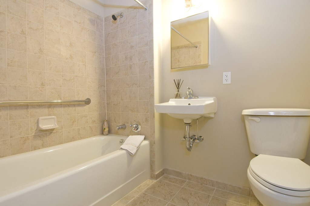 a bathroom with a toilet sink and bath tub