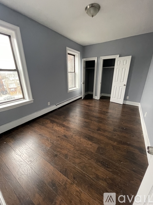 A room with wooden floors and white doors.