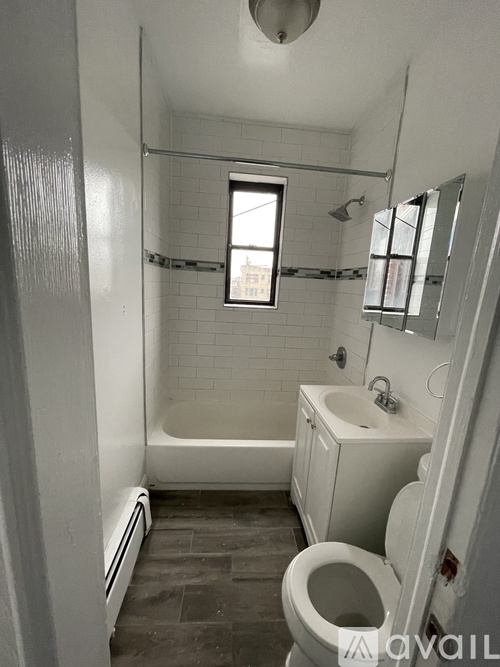 A bathroom with a toilet, sink, and bathtub.