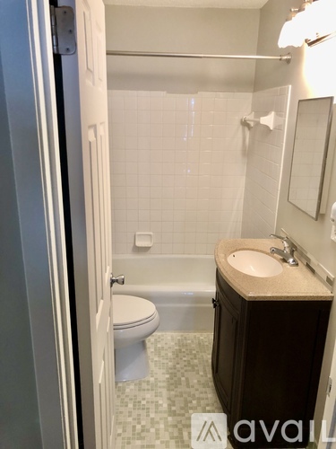 Two white front loading washing machines in a room.