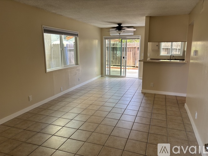 A living room with a couch, chair, and television.