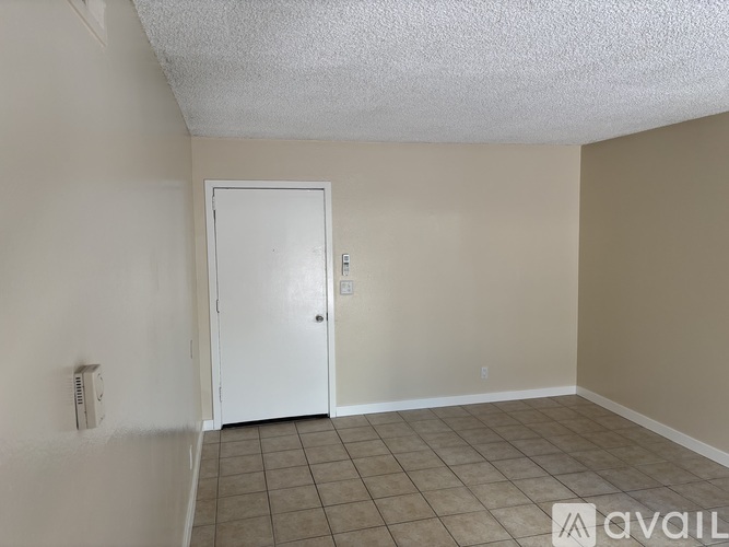 A kitchen and dining area with a table and chairs.