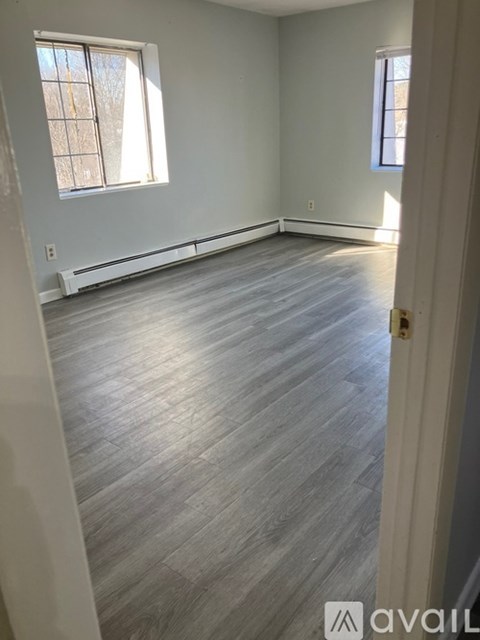 A room with light grey flooring and white walls.