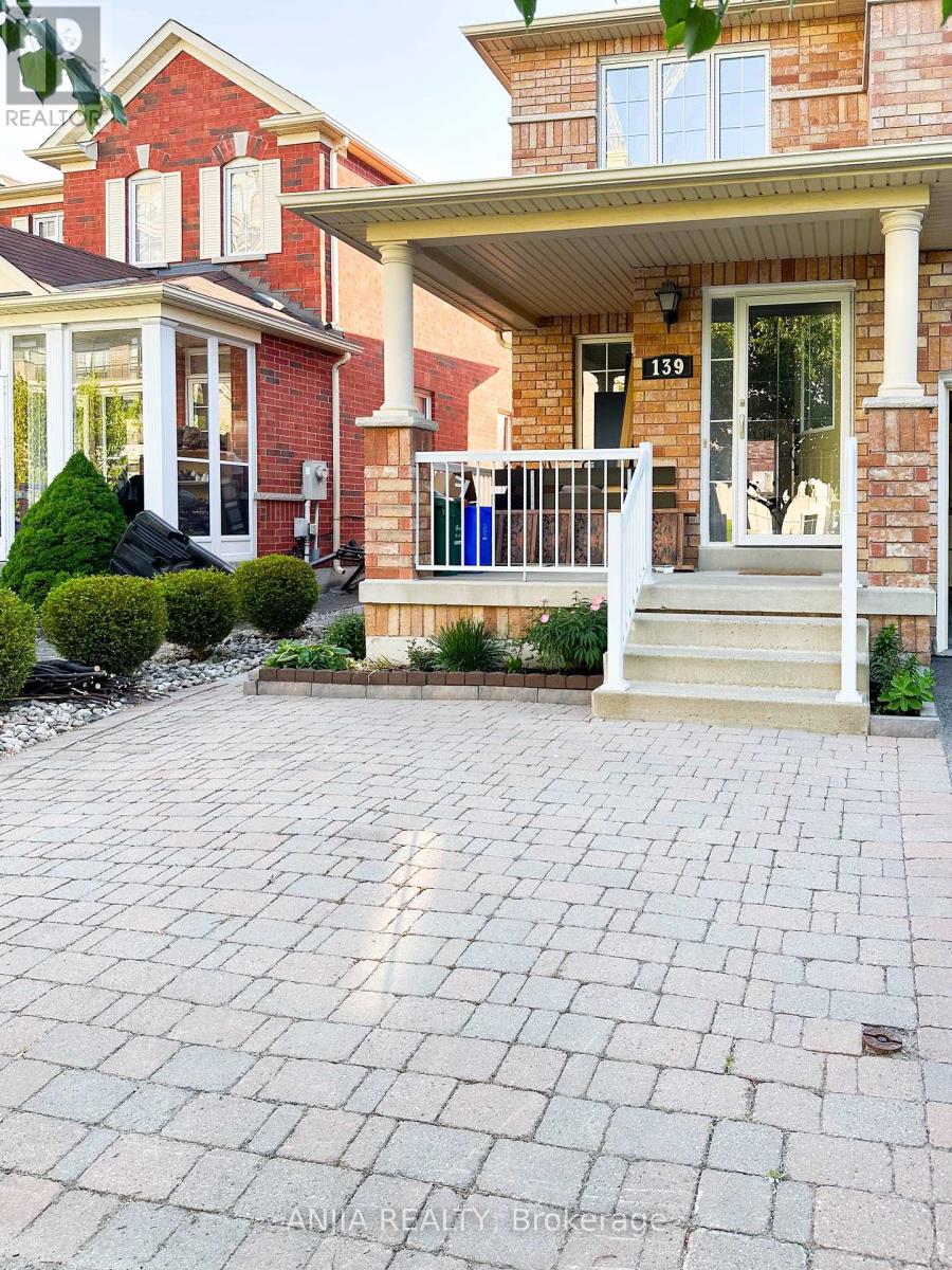 A brick house with a white porch and a number 159 on the door.