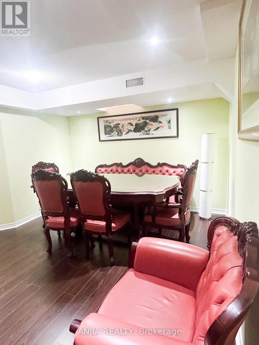 A dining room with a table and chairs.