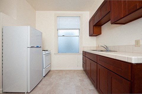 a kitchen with a refrigerator and a sink