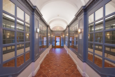 a hallway with many windows and a door