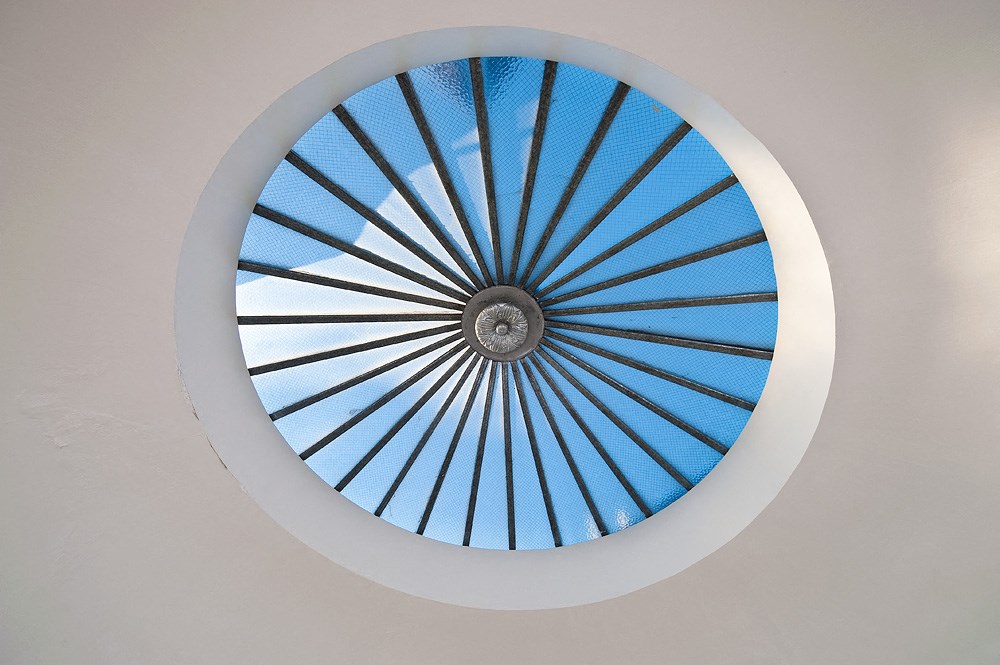 a circular window with a blue sky view through it