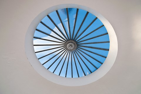 a circular window with a blue sky view through it