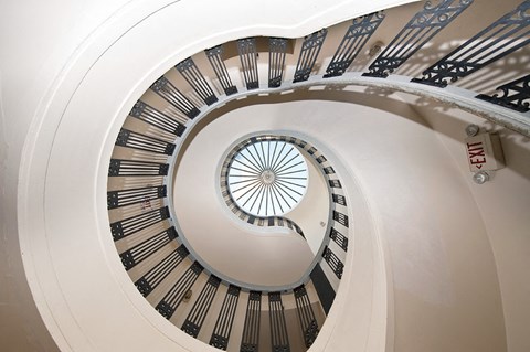a view of a spiral staircase from the top of it