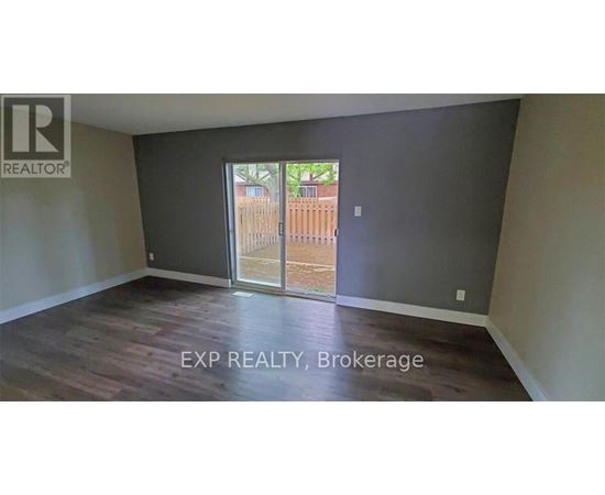 A room with EXP REALTY, Brokerage written on the floor.