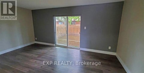 A room with EXP REALTY, Brokerage written on the floor.