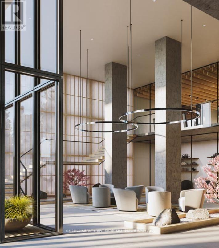 A modern interior space with a glass wall, a hanging light fixture, and a variety of seating options.