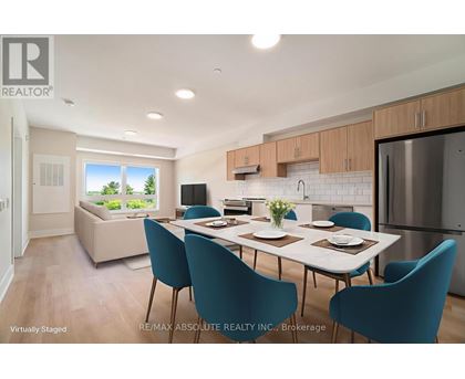 A dining room with a table set for four and a kitchen area in the background.