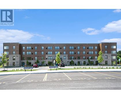 A large building with a parking lot in front of it.