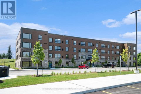 A large building with a parking lot in front of it.