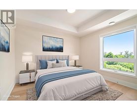 A bedroom with a large bed and a window overlooking a green landscape.