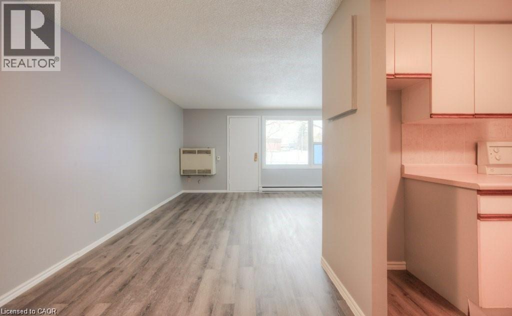 A room with a window and a door leading to another room.