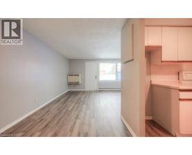 A room with a window and a door leading to another room.