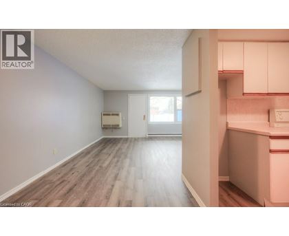 A room with a window and a door leading to another room.