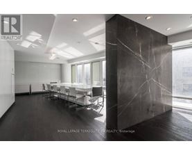 A conference room with a long table and chairs.