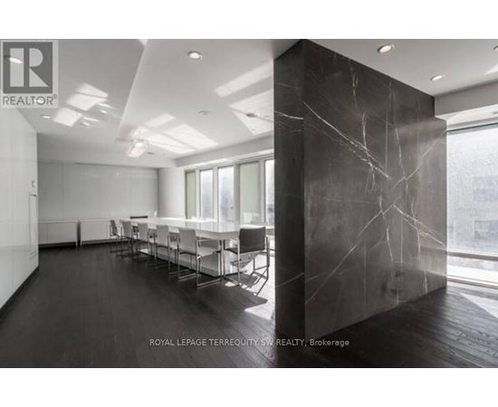 A conference room with a long table and chairs.