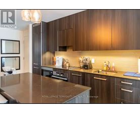 A modern kitchen with dark wood cabinets and a central island.