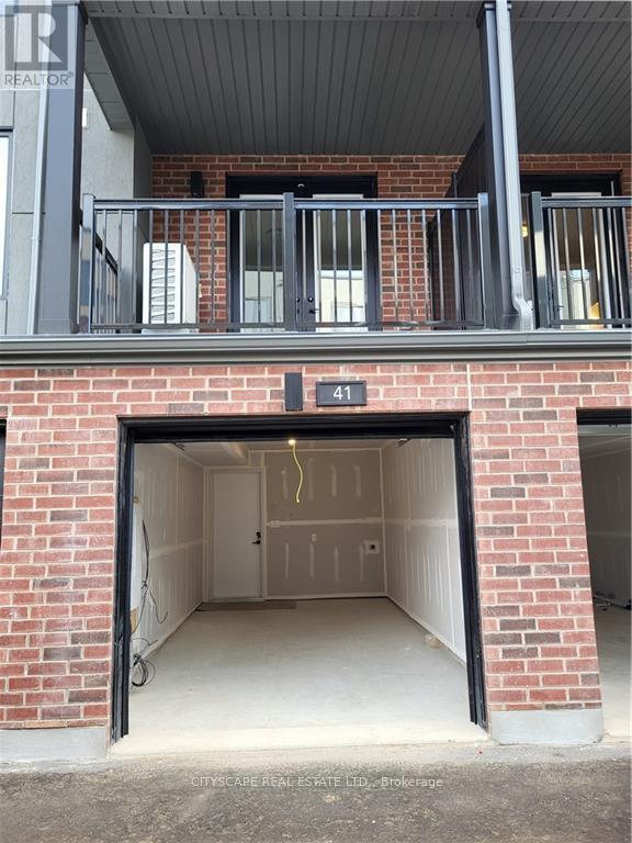 A garage door is open to reveal a clean, empty garage inside.