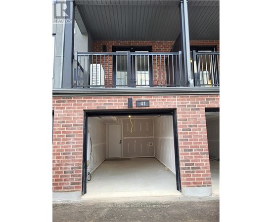 A garage door is open to reveal a clean, empty garage inside.