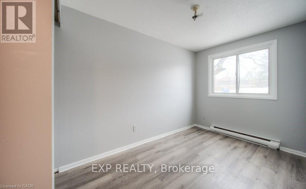 A room with a window and a radiator on the floor.