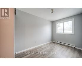 A room with a window and a radiator on the floor.