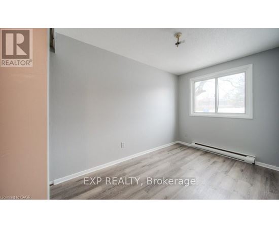 A room with a window and a radiator on the floor.