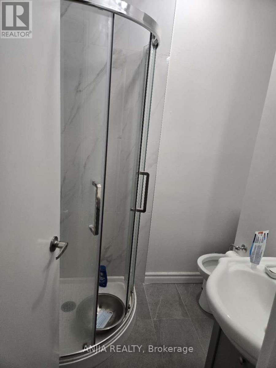 A bathroom with a sink, toilet and shower.