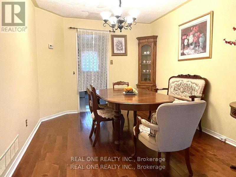 A dining room with a wooden table and chairs.