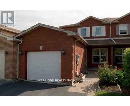 A red brick house with a white garage door.