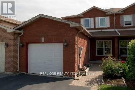 A red brick house with a white garage door.