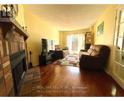 A living room with a fireplace and a couch.