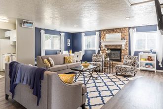 a living room with couches and chairs and a fireplace