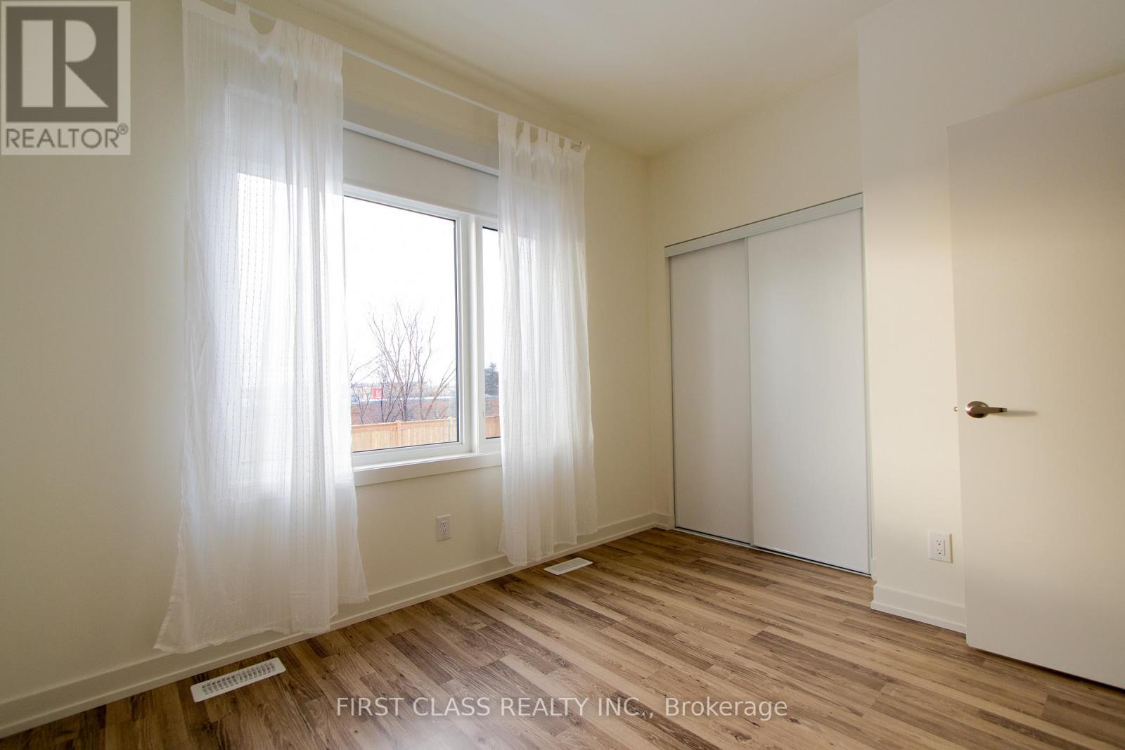 A room with a window and a door is for sale.