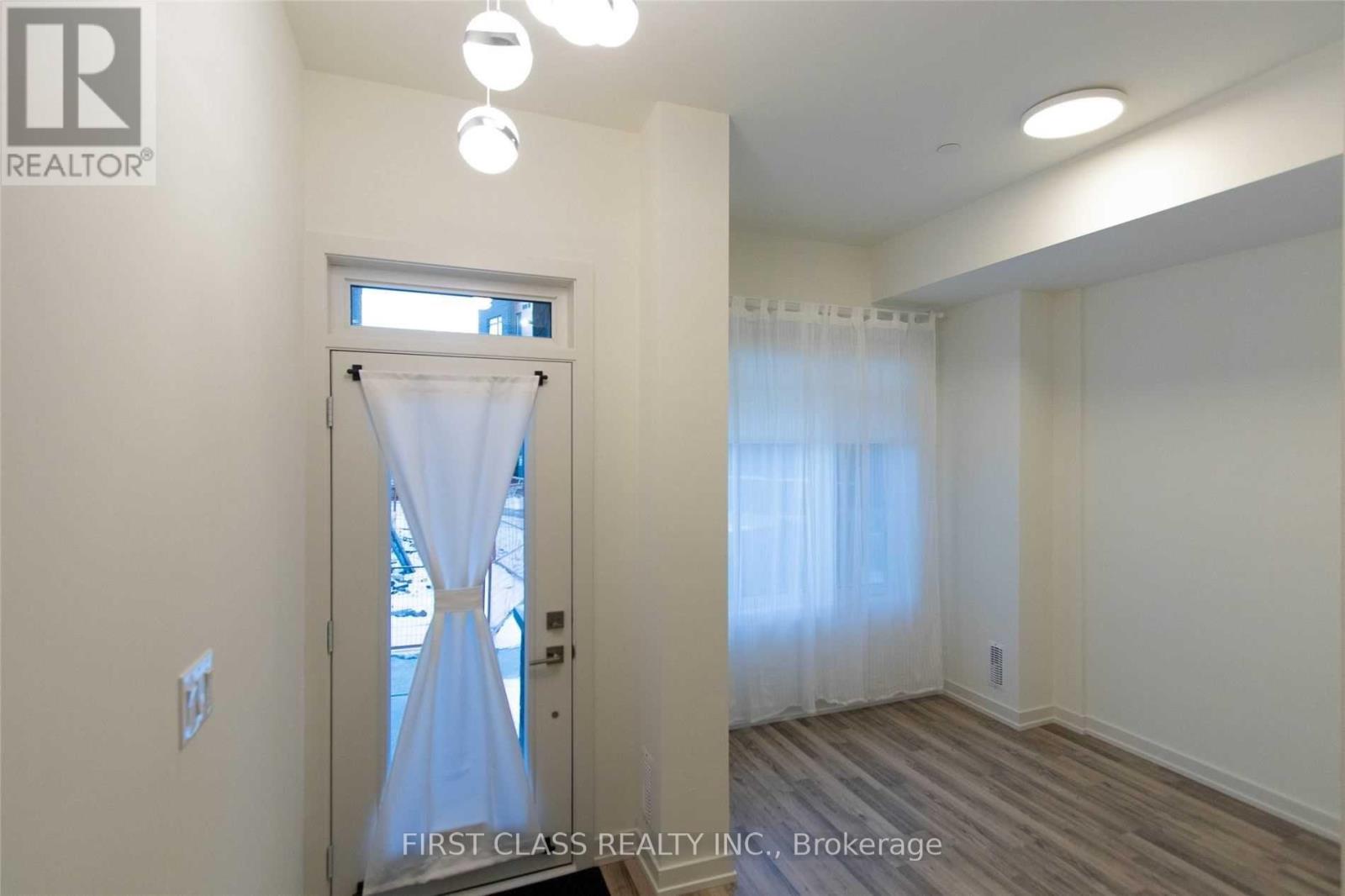 A room with a door covered in a white cloth.