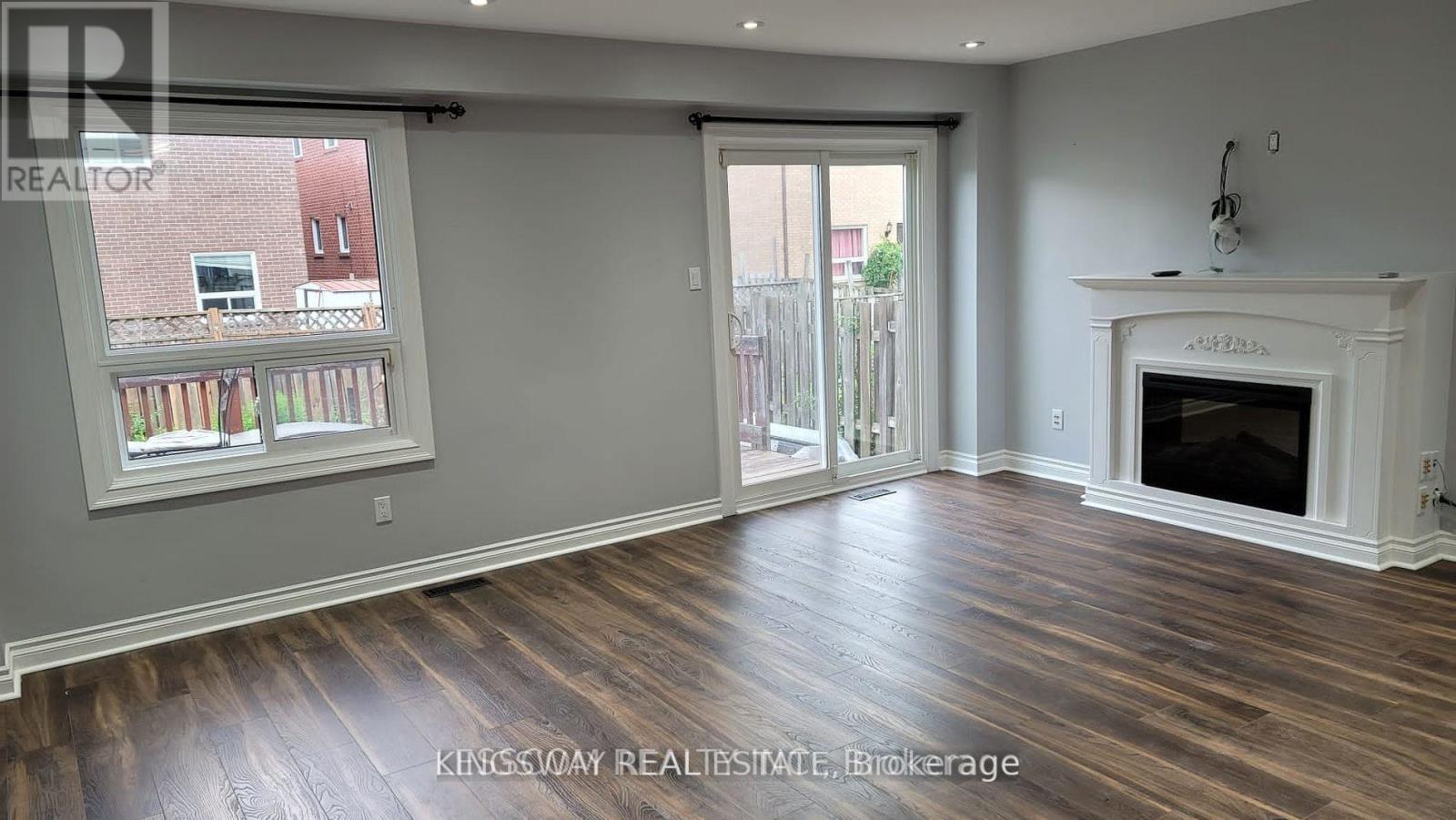 A living room with a fireplace and sliding glass doors.