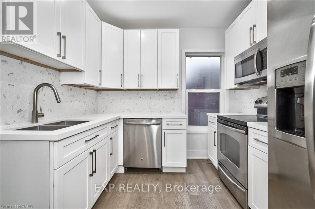 A kitchen with white cabinets and stainless steel appliances.