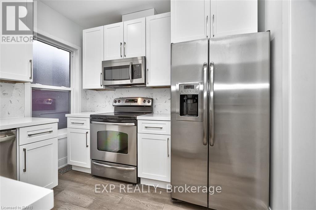 A kitchen with white cabinets and stainless steel appliances.