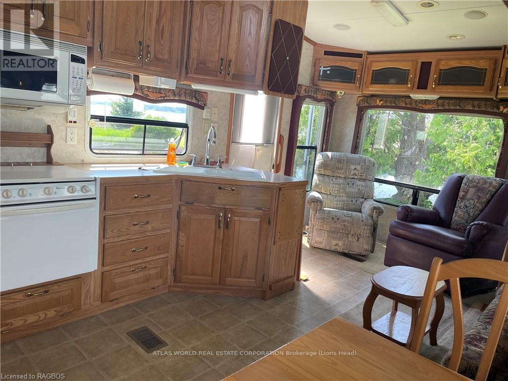 A kitchen area with wooden cabinets and a white stove.