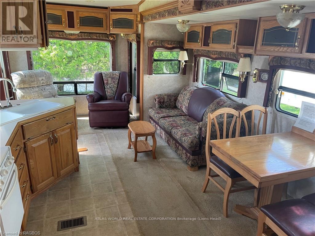 A living room with a couch, chair, and table.