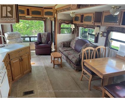 A living room with a couch, chair, and table.
