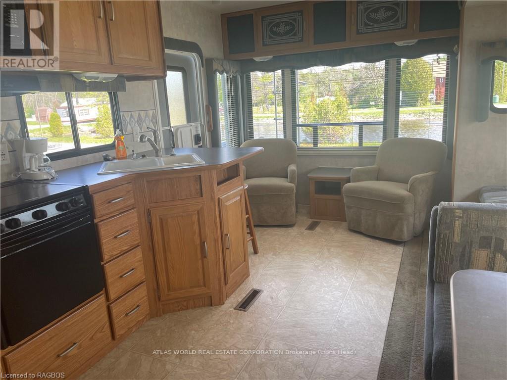A kitchen with wooden cabinets and a black stove top oven.