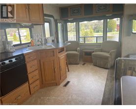 A kitchen with wooden cabinets and a black stove top oven.
