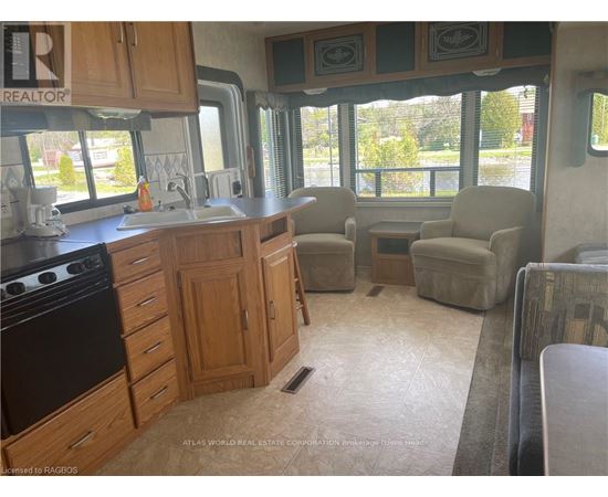 A kitchen with wooden cabinets and a black stove top oven.
