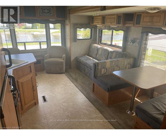 A living room with a couch, chair, and table.